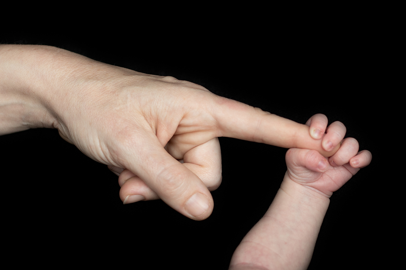 Small child's hand holfing on to dads finger — Bloomington Normal family photographer Martina Newport Photography