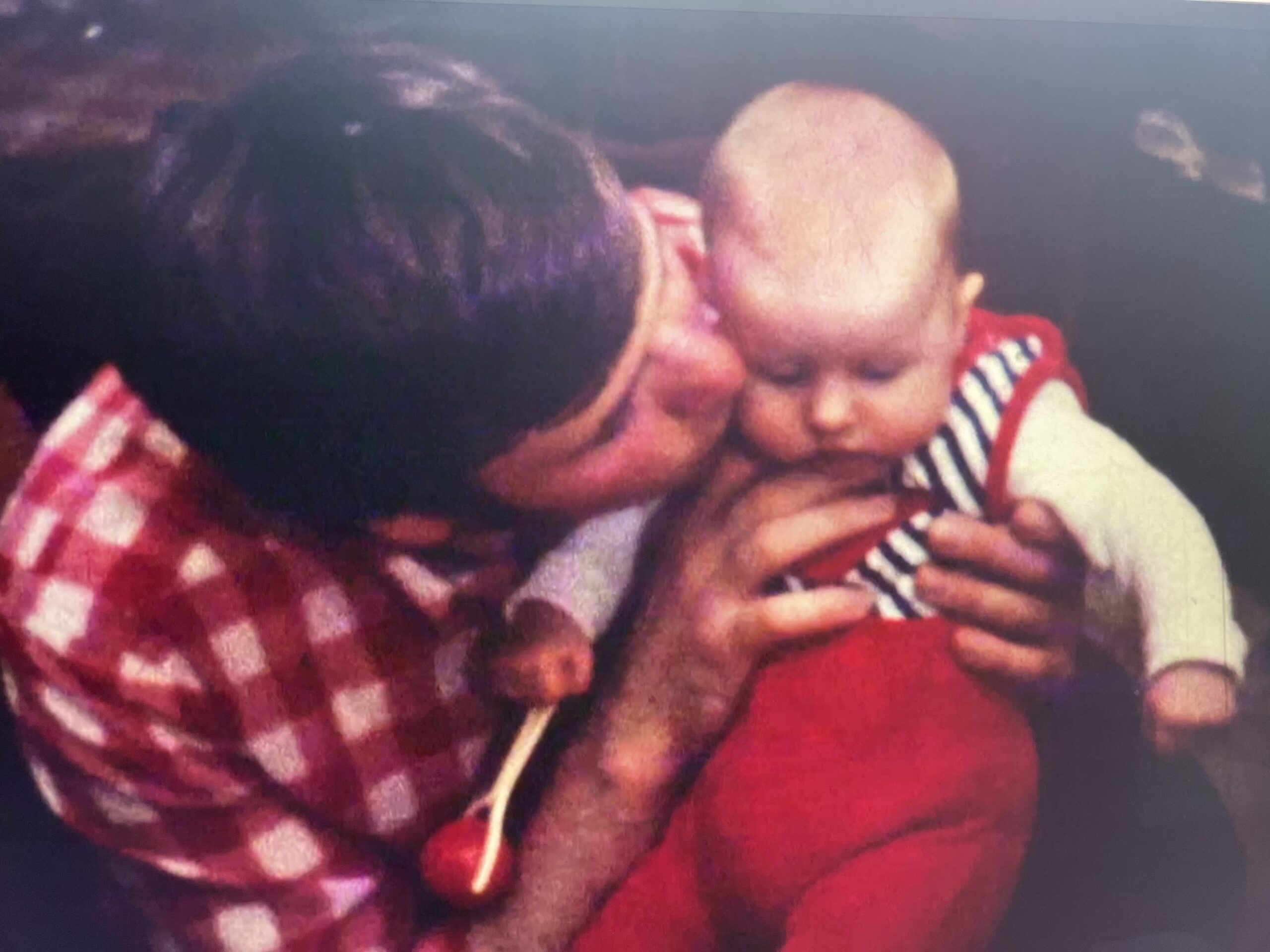 father holding her child old family photograph